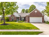 Charming brick home with a manicured lawn and attached two-car garage in a desirable neighborhood at 11419 Niagara Dr, Fishers, IN 46037