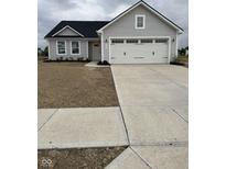 Charming single-story home with a large garage, gray siding, and a neatly paved driveway at 1193 Brightwood Cir, Greenfield, IN 46140