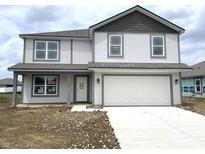 Charming two-story home with gray and white accents and a two-car garage at 1204 Mcbride St, Greenfield, IN 46140