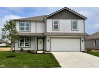 Charming two-story home with a well-manicured lawn, two-car garage, and light gray siding at 1204 Mcbride St, Greenfield, IN 46140