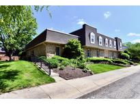 Inviting brick townhouse with a well-manicured lawn and charming curb appeal at 1310 Kings Cove Ct, Indianapolis, IN 46260