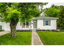 Charming single-story home with a well-manicured lawn and welcoming front porch at 1431 N Bolton Ave, Indianapolis, IN 46219