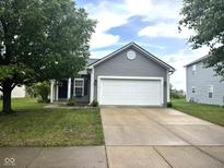 Charming single-story home featuring a two-car garage, neat landscaping, and a classic gray exterior at 160 Rambling Rd, Greenfield, IN 46140