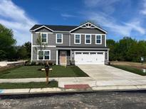 Charming two-story home with gray siding, white trim, an attached two car garage, and a neatly manicured lawn at 1684 Bayberry Dr, Greenfield, IN 46140