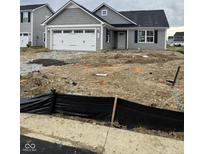Charming gray single-story home with a two-car garage and undergoing landscaping at 1730 Juniper Ln, Greenfield, IN 46140