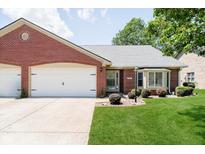Charming brick home featuring an attached garage and beautifully maintained front lawn at 194 Waterford Ct, Avon, IN 46123