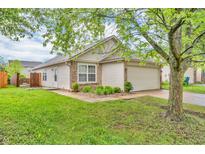 Charming single-story home featuring a well-manicured lawn, attached garage, and neutral siding at 2740 Braxton Dr, Indianapolis, IN 46229