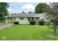 Charming single-story home with a well-manicured lawn and attached carport at 2840 W 12Th St, Anderson, IN 46011