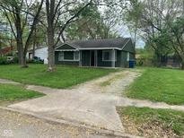 Charming single-story home featuring a cozy porch and a well-maintained lawn at 3742 N Wittfield St, Indianapolis, IN 46235