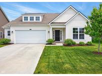 Charming home featuring a well-maintained lawn, attached garage, and inviting front entrance at 4367 Homestead Dr, Whitestown, IN 46075