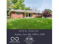 Charming single-story brick home with a well-manicured lawn and mature trees at 7135 Huntington Rd, Indianapolis, IN 46240