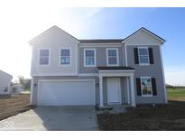Charming two-story home with gray siding, white trim, an attached garage and a well-lit front porch at 7323 Waylon Way, Indianapolis, IN 46239