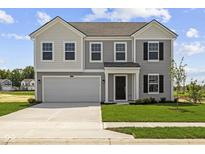 Charming two-story home with gray siding, a two-car garage, and a well-manicured lawn at 7323 Waylon Way, Indianapolis, IN 46239
