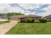 Charming brick ranch-style home featuring a well-manicured lawn and mature landscaping at 897 N Scott Dr, Greenwood, IN 46142
