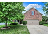 Charming brick home with well-manicured lawn, attached garage, and beautiful landscaping at 10412 Cedar Dr, Fishers, IN 46037