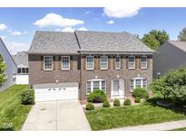 Beautiful two-story brick home featuring a well-manicured lawn and attached two car garage at 12612 Majestic Way, Fishers, IN 46037