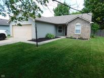 Charming single-story home with a well-maintained lawn, attached garage, and inviting curb appeal at 1612 Prairieview Ln, Greenfield, IN 46140