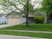 Charming single-story home with a well-maintained lawn and mature shade tree in a suburban neighborhood at 1612 Prairieview Ln, Greenfield, IN 46140