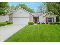 Charming single-story home with a manicured lawn, attached garage, and inviting front entrance at 16768 Maraschino Dr, Noblesville, IN 46062