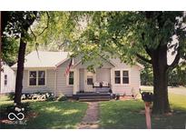 Charming bungalow with mature trees, quaint front porch, and neatly manicured lawn at 2100 N Janney Ave, Muncie, IN 47304