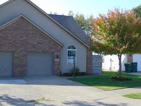 Charming home features a two-car garage, a well-maintained lawn, and a mature tree with colorful leaves at 2116 Galaxy Dr, Franklin, IN 46131
