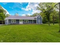 Charming single-story home boasts a well-manicured lawn and inviting front porch, perfect for enjoying the outdoors at 2935 N Grizzly Ln, Martinsville, IN 46151
