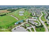 Stunning aerial view of community golf course, clubhouse, pool, and tennis courts at 3832 Boundary Bay Dr, Indianapolis, IN 46217