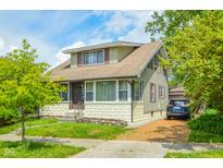 Charming two-story home with well-maintained lawn, and a private driveway in a desirable location at 4163 Otterbein Ave, Indianapolis, IN 46227