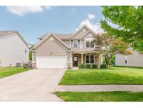 Charming two-story home featuring a two-car garage, well-manicured lawn, and inviting front porch at 5913 Monticello Square Ln, Indianapolis, IN 46234