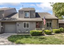 Charming townhome featuring a well-manicured lawn, lovely landscaping, and an attached one-car garage at 601 Conner Creek Dr, Fishers, IN 46038