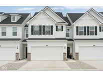 New construction townhouse with attached garage, black shutters and gray landscaping at 7258 Selah Ln, Noblesville, IN 46062