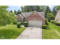 Charming brick home featuring manicured landscaping and an attached two car garage at 7335 Pymbroke Dr, Fishers, IN 46038