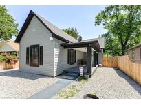 Charming one-story home with gravel landscaping and a covered front porch, providing a welcoming curb appeal at 853 S Belleview Pl, Indianapolis, IN 46221