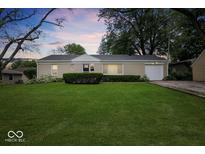 Charming single-story home with a well-manicured front lawn and attached garage at 953 W Clinton St, Danville, IN 46122