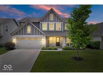 Charming two-story home featuring a well-manicured lawn and an attached two-car garage at 10993 Liberation Trce, Noblesville, IN 46060