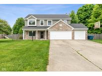 Charming two-story home features a large yard, attached garage, and inviting front porch at 113 Spring Creek Ct, Noblesville, IN 46062