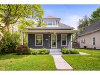 Charming blue two-story home with a cozy front porch and landscaped front yard at 117 S Spencer Ave, Indianapolis, IN 46219