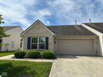 Charming single-story home featuring a brick facade, blue shutters, and an attached two-car garage at 11711 Whisper Cove Dr, Fishers, IN 46037