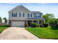 Attractive two-story home featuring a well-kept lawn, attached garage, and welcoming entrance at 12331 Chiseled Stone Dr, Fishers, IN 46037