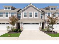 Charming townhome with two-car garage, stylish siding, and meticulously landscaped front yard at 1280 Newton St, Avon, IN 46123