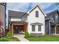 Charming two-story home with a welcoming front porch and beautifully landscaped front yard at 1310 Olive St, Indianapolis, IN 46203