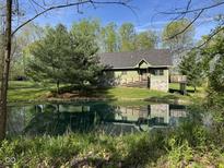 Charming home featuring an inviting exterior with a pond in the front yard creating a serene and picturesque setting at 1340 Apache Trl, Martinsville, IN 46151