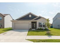 Charming one-story home featuring a gray brick facade, a two-car garage, and a well-manicured front lawn at 1483 Paper Birch Dr, Sheridan, IN 46069