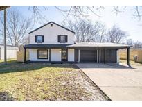 Charming two-story home with a spacious driveway and an attached two car garage at 1808 Raible Ave, Anderson, IN 46011