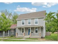 Charming two-story home with a covered porch, vinyl siding, and a well-maintained front yard at 2229 N Arsenal Ave, Indianapolis, IN 46218