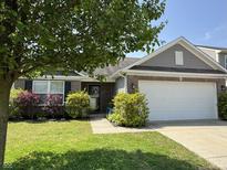 Charming single-Gathering home features a well-manicured lawn and attached two car garage at 2911 W Hawanian Ln, Monrovia, IN 46157