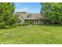 Charming home featuring a well-manicured lawn, inviting front porch and lovely landscaping at 3631 S 450 E, Whitestown, IN 46075