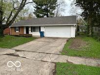 Charming single-story home with a well-manicured lawn and a two-car attached garage at 4108 Steinmetz Dr, Indianapolis, IN 46254