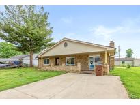Charming single-story home with stone facade, covered porch, and well-maintained lawn at 521 Sunset Dr, Edinburgh, IN 46124