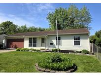 Charming single-story home with a well-manicured lawn and mature landscaping at 5416 Straw Hat Dr, Indianapolis, IN 46237
